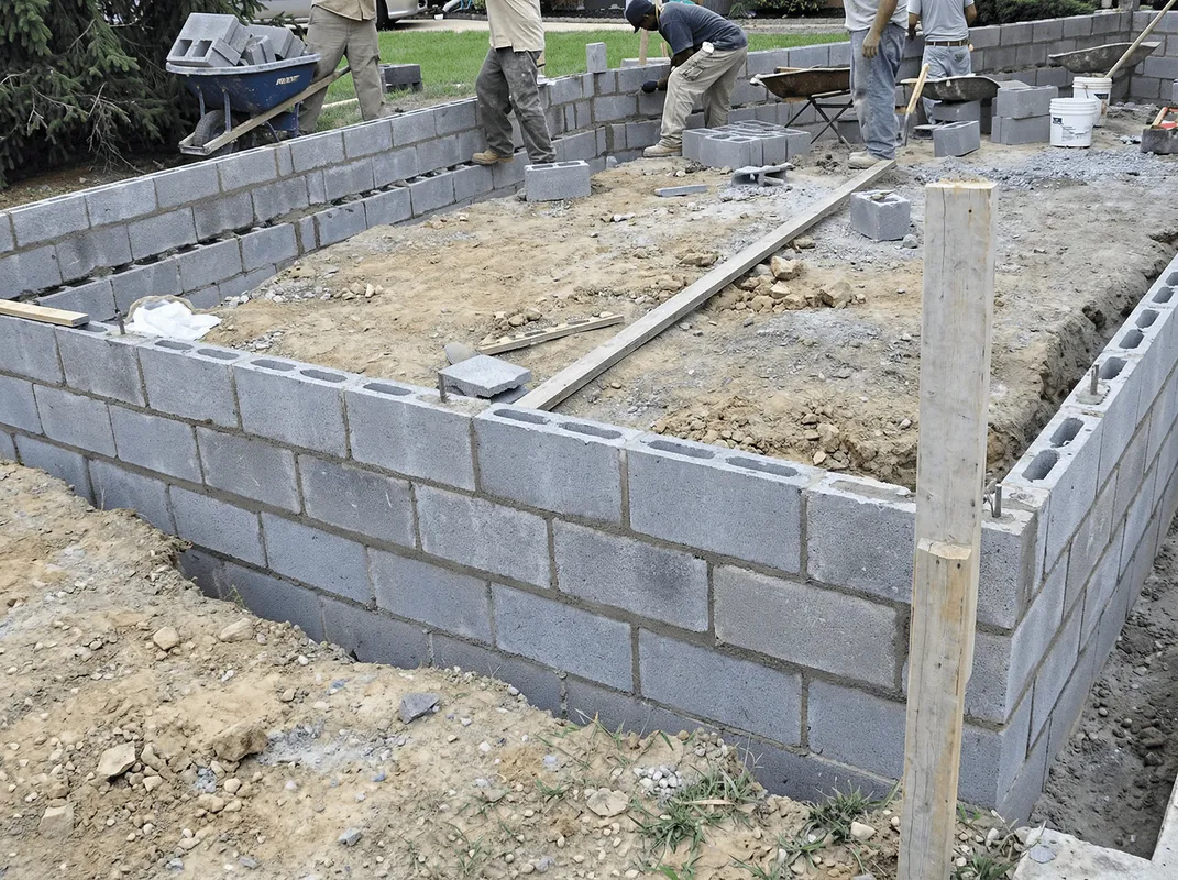 Professionals building a foundation with blocks in Manchester, NH