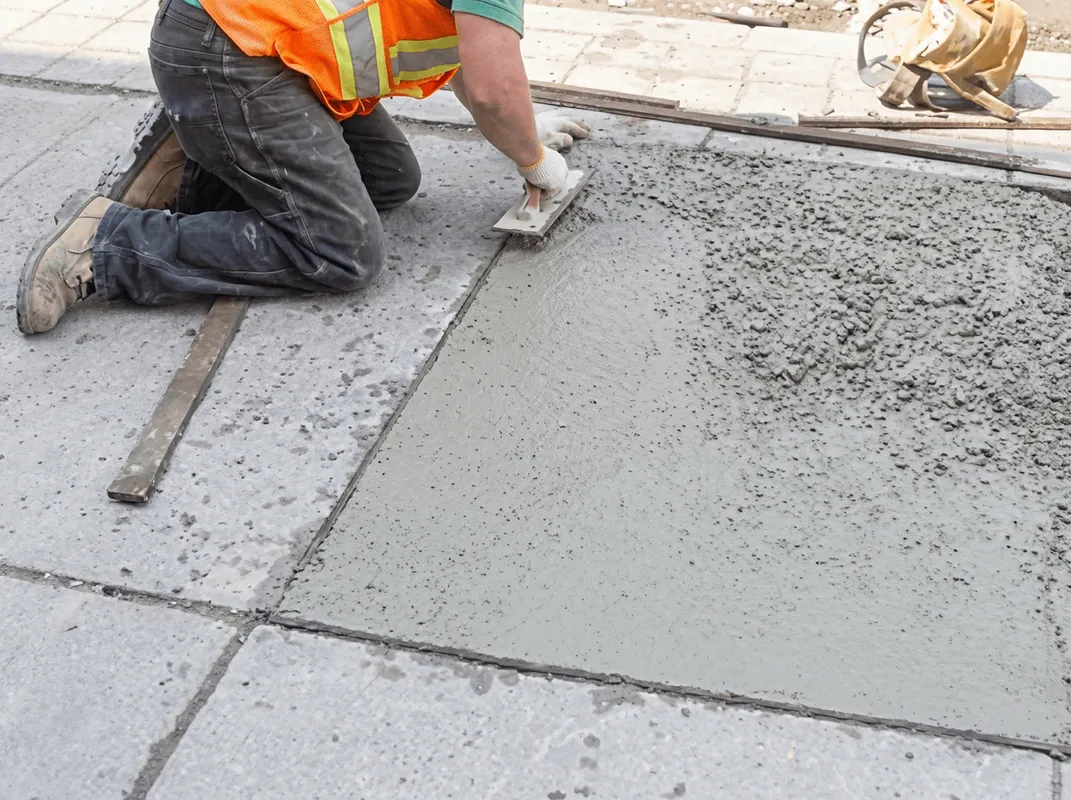 Professional repairing a concrete floor in Manchester, NH